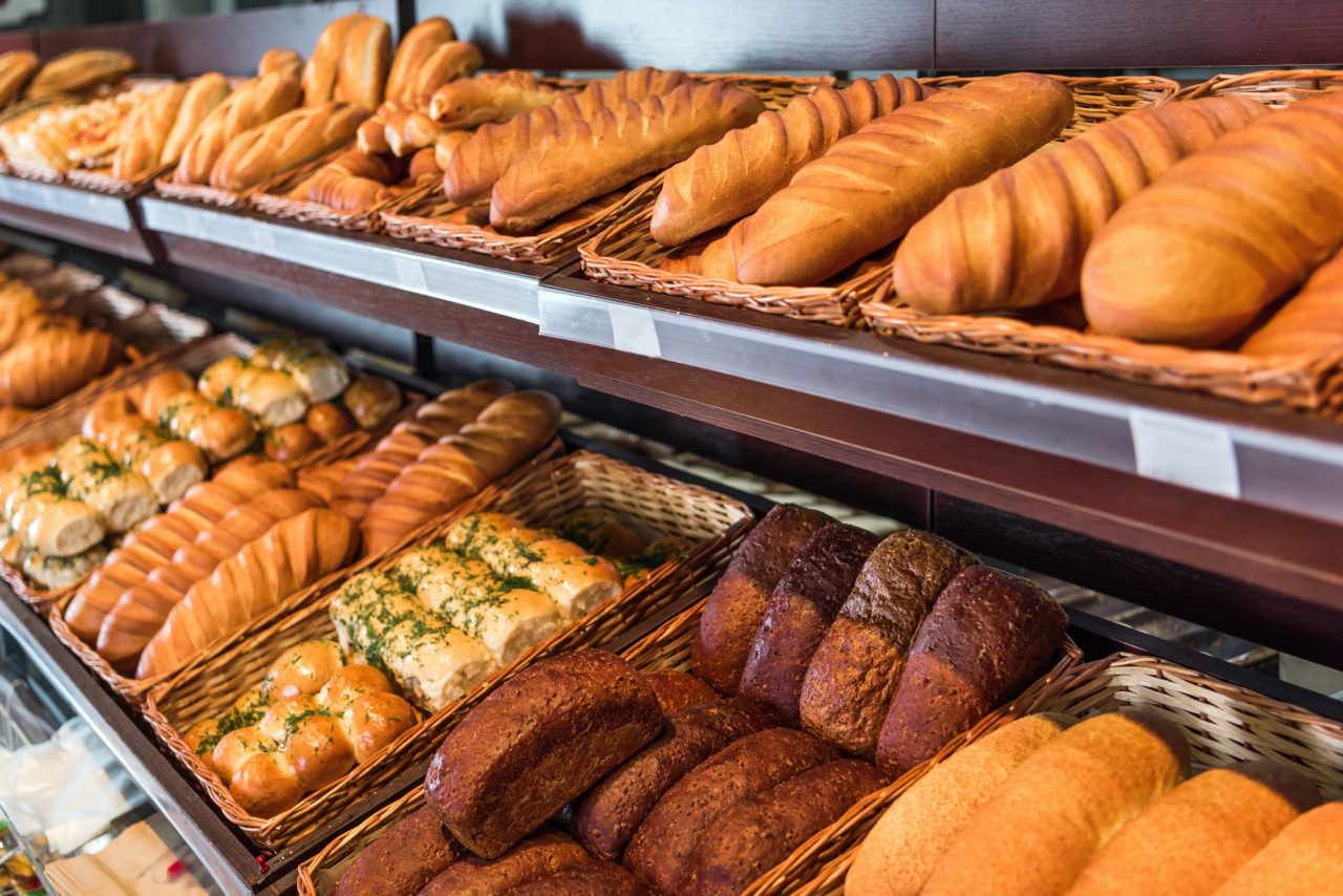 selective focus of freshly baked various bread in pastry department of grocery store